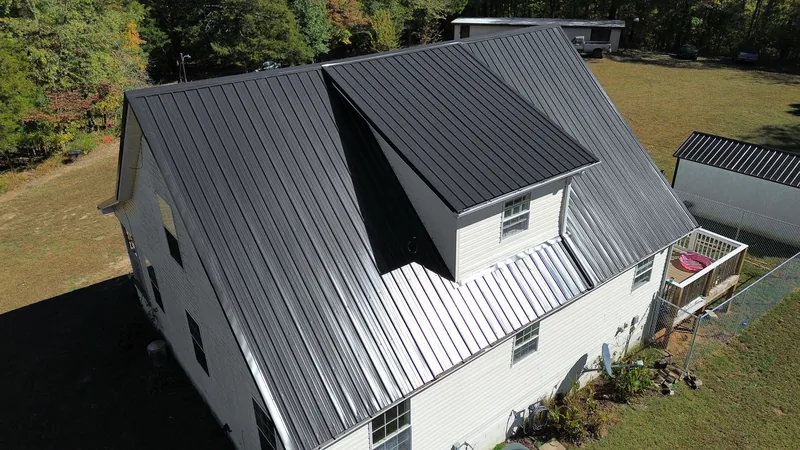 The big shed dormer out back, with the afternoon sun glinting off the new panels
