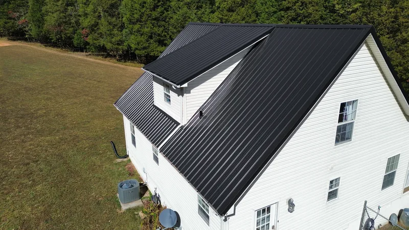 Out back: the gable end and the big shed dormer, all in black Ag panel