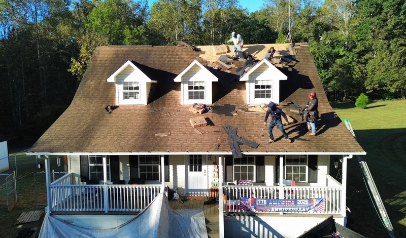 Tear-off day: the TRS crew stripping the old shingles around the dormers