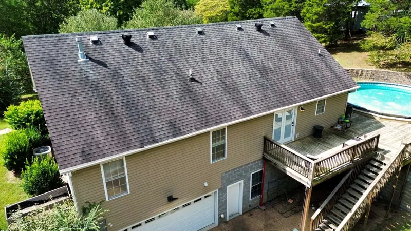 Two-story home with a pool before the re-roof