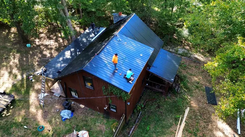 TRS crew installing a metal roof, seen from the drone