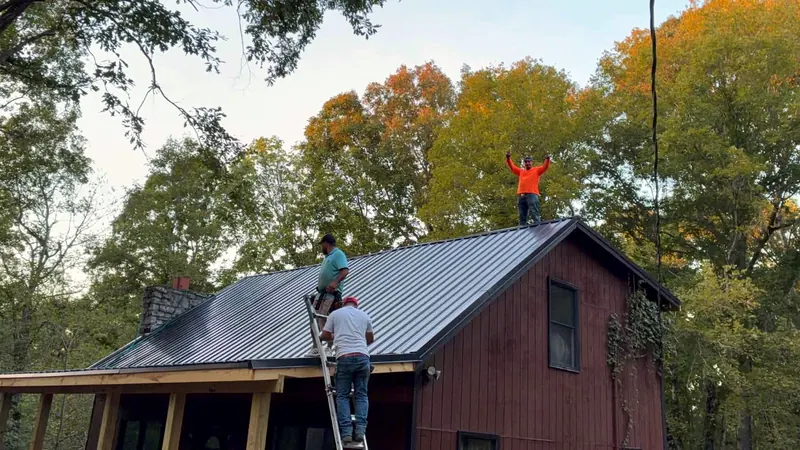 Crew on the ladder setting metal panels