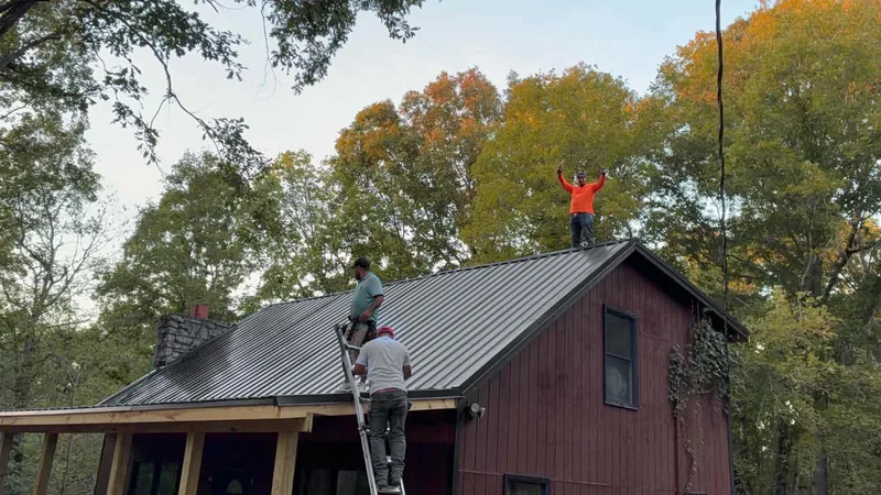 Crew member on a ladder setting metal panels